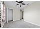 Bedroom with ceiling fan, closet, and grey carpet at 2108 Lemon St, Haines City, FL 33844
