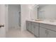 Modern bathroom with dual sinks and a large walk-in shower at 356 Citrine Loop, Kissimmee, FL 34758