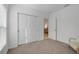 Well-lit bedroom with double sliding doors leading to another room at 356 Citrine Loop, Kissimmee, FL 34758