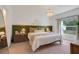 Cozy bedroom with green accent wall, queen bed, and ample natural light at 356 Citrine Loop, Kissimmee, FL 34758