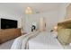Main bedroom with a king-size bed, large TV, and access to bathroom at 356 Citrine Loop, Kissimmee, FL 34758