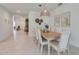 Bright dining area with light wood table and seating for eight at 356 Citrine Loop, Kissimmee, FL 34758