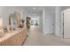 Bright and airy entryway with light wood console table and mirror at 356 Citrine Loop, Kissimmee, FL 34758