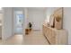 Spacious entryway with light wood console table and view to living room at 356 Citrine Loop, Kissimmee, FL 34758