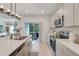 Open concept kitchen with stainless steel appliances and a view of the backyard at 356 Citrine Loop, Kissimmee, FL 34758