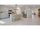 Bright kitchen featuring an island with seating, stainless steel appliances, and light gray cabinets at 356 Citrine Loop, Kissimmee, FL 34758