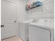 Laundry room with washer, dryer, and overhead shelving at 356 Citrine Loop, Kissimmee, FL 34758