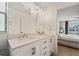 Bathroom featuring double sinks and a view into bedroom at 3940 Canoe Creek Rd, Saint Cloud, FL 34772