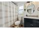 Updated bathroom with a dark vanity, marble countertop, and a stylish shower curtain at 3940 Canoe Creek Rd, Saint Cloud, FL 34772