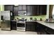Modern kitchen with stainless steel appliances and dark wood cabinets at 4317 Acorn Ct, Davenport, FL 33837
