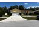 House exterior with a two-car garage and a spacious driveway at 481 Peppermill Cir, Kissimmee, FL 34758