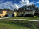 One-story house with a two-car garage and well-maintained lawn at 481 Peppermill Cir, Kissimmee, FL 34758