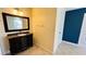Bathroom with granite vanity, mirror, and tile floor at 5773 Gatlin Ave # 627, Orlando, FL 32822
