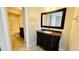 Bathroom with granite vanity and a large mirror at 5773 Gatlin Ave # 627, Orlando, FL 32822