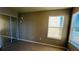 Bedroom with mirrored closet doors and two windows at 5773 Gatlin Ave # 627, Orlando, FL 32822