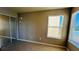 Bedroom with mirrored closet doors and two windows at 5773 Gatlin Ave # 627, Orlando, FL 32822