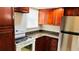 Kitchen features granite counters and wood cabinets at 5773 Gatlin Ave # 627, Orlando, FL 32822