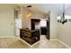 Kitchen with breakfast bar and dark wood cabinets at 5773 Gatlin Ave # 627, Orlando, FL 32822