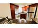 Kitchen features granite counters and wood cabinets at 5773 Gatlin Ave # 627, Orlando, FL 32822