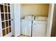 Bright laundry room with washer, dryer, and window at 5773 Gatlin Ave # 627, Orlando, FL 32822