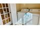 Laundry room with washer and dryer and French doors at 5773 Gatlin Ave # 627, Orlando, FL 32822