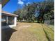 Spacious backyard with screened patio and tree coverage at 824 San Pedro Ct, Kissimmee, FL 34758