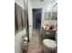 Full bathroom with toilet and vanity, view into hallway at 824 San Pedro Ct, Kissimmee, FL 34758