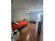 Bedroom with orange bedding, wood floors, and a small bench at 824 San Pedro Ct, Kissimmee, FL 34758