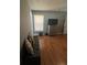 Bedroom with wood floors, a sofa, and a dresser with a TV at 824 San Pedro Ct, Kissimmee, FL 34758