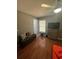 Bedroom with wood floors, a bench, and a dresser at 824 San Pedro Ct, Kissimmee, FL 34758