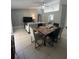 Open concept dining area with a large wooden table at 824 San Pedro Ct, Kissimmee, FL 34758