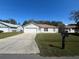 Cute one-story home with a large driveway and well-maintained lawn at 824 San Pedro Ct, Kissimmee, FL 34758