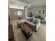 Living room features sectional sofa, coffee table, and plenty of natural light at 824 San Pedro Ct, Kissimmee, FL 34758