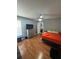 Main bedroom with an orange bed, wood floors, and a dresser at 824 San Pedro Ct, Kissimmee, FL 34758