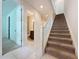 Modern staircase with neutral carpeting and tile flooring at 10090 Sunnifa Aly, Orlando, FL 32832