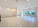 Spacious living room with tile floors and a view from two large windows at 10090 Sunnifa Aly, Orlando, FL 32832