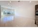 Open living area with tile flooring and large windows offering natural light at 10090 Sunnifa Aly, Orlando, FL 32832