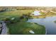 Aerial view of a lush green golf course with lake views at 10090 Sunnifa Aly, Orlando, FL 32832