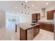 Modern kitchen with island, stainless steel appliances, and granite counters at 10090 Sunnifa Aly, Orlando, FL 32832