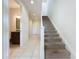 Modern staircase with neutral carpeting and tile flooring at 10090 Sunnifa Aly, Orlando, FL 32832