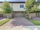 Townhome with a two-car garage and brick driveway at 10090 Sunnifa Aly, Orlando, FL 32832