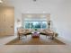 Bright living room with large window, comfortable seating, and stylish rug at 10090 Sunnifa Aly, Orlando, FL 32832