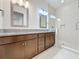 Double vanity bathroom with a large walk-in shower and granite countertop at 10090 Sunnifa Aly, Orlando, FL 32832