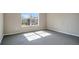 Bright bedroom with a large window and gray carpeting at 1060 Rock Harbor Ave, Orlando, FL 32828