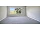 Spacious bedroom with large window and gray carpeting at 1060 Rock Harbor Ave, Orlando, FL 32828