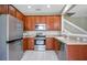 Galley kitchen with wood cabinets, stainless steel appliances, and granite countertops at 1060 Rock Harbor Ave, Orlando, FL 32828