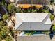 Aerial view of the property showing metal roof and landscaping at 3075 Key Lime Loop, Kissimmee, FL 34747
