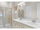 Bathroom boasts dual sinks, a large mirror, and a walk-in shower at 3075 Key Lime Loop, Kissimmee, FL 34747