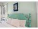 Bedroom with a teal headboard and white bedding at 3075 Key Lime Loop, Kissimmee, FL 34747