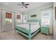 Peaceful bedroom with teal four-poster bed and natural light at 3075 Key Lime Loop, Kissimmee, FL 34747